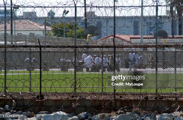 The exercise yard and inmates at the Federal Correctional Institution building on Terminal Island San Pedro Los Angeles California USA