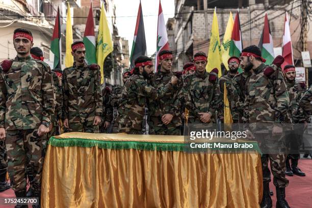 Hezbollah supporters in military clothes in formation within the area where the coffin will be honored moments before the beginning of the funeral of...