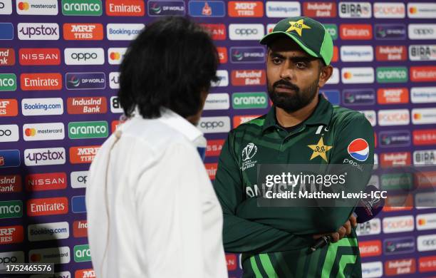 Babar Azam of Pakistan looks on as they are interviewed by Ramiz Raja following the ICC Men's Cricket World Cup India 2023 between Pakistan and...