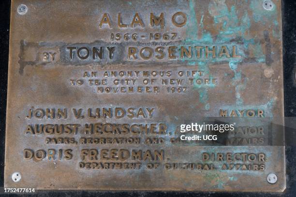 Weathered, patinaed plaque commemorates Alamo, also known as the Astor Place Cube or The Cube, a giant black sculpture created by Tony Rosenthal in...