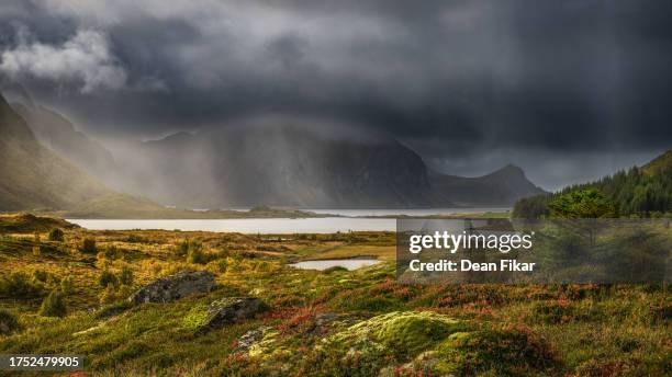 rainy afternoon in the lofoten islands - ominous mountains stock pictures, royalty-free photos & images