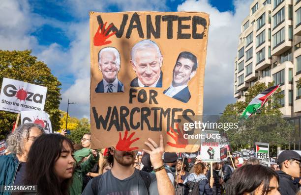 Pro-Palestinian protester holds a placard accusing Biden, Sunak and Netanyahu of war crimes at a demonstration against Israeli attacks on Gaza in...