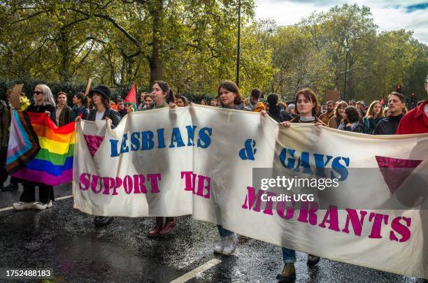 Gay women with a banner reading, "Lesbian & Gays support the migrants" march with pro-Palestinian protesters at a mass demonstration against Israeli...