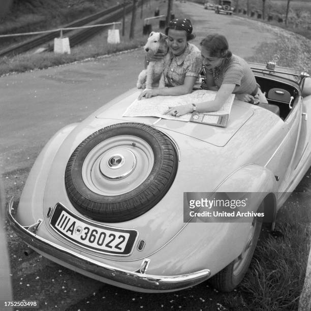Two women with a Mercedes Benz convertible, Germany 1930s.