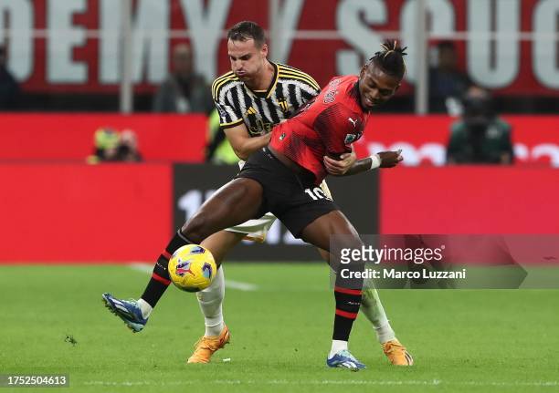 Rafael Leao of AC Milan on the ball whilst under pressure from Federico Gatti of Juventus FC during the Serie A TIM match between AC Milan and...