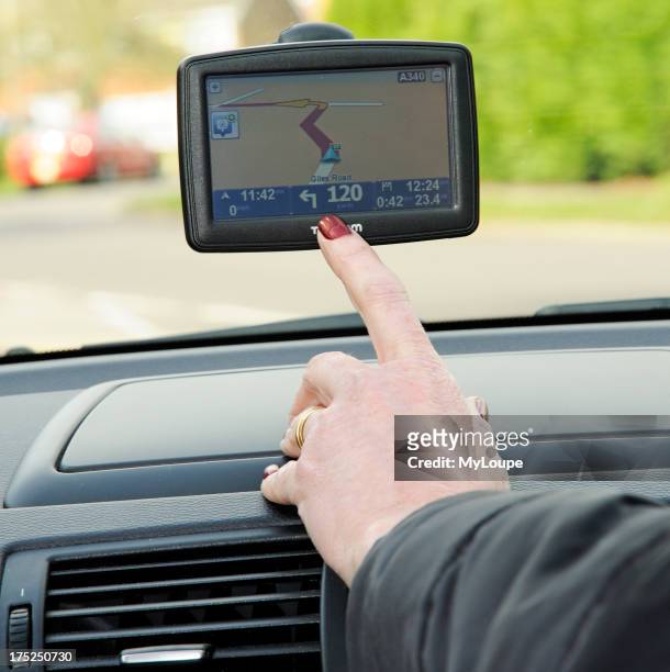 Woman driver using a TomTom satellite navigation device