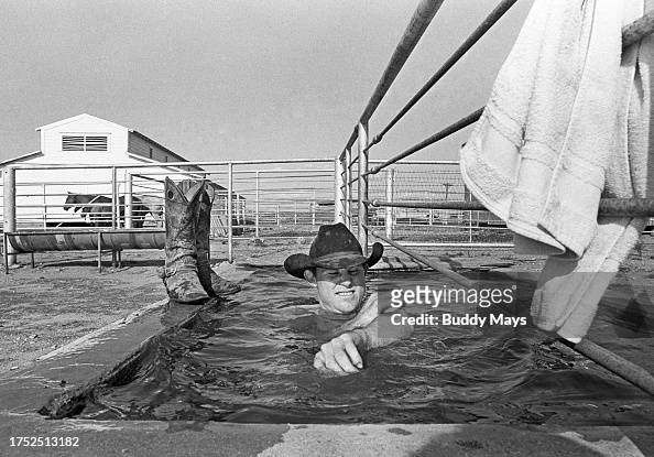 Cxowboy Bathing In A Stock Tank