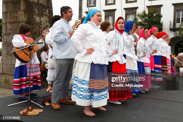 Azorean folk music group, wearing traditional garments, performing at the city gates in Ponta Delgada, Azores, Portugal