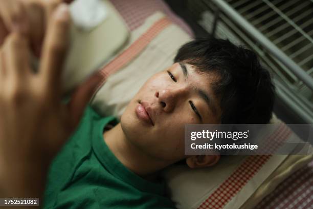 a teen with type diabetes checks his mobile app monitor - glucose chart stock pictures, royalty-free photos & images