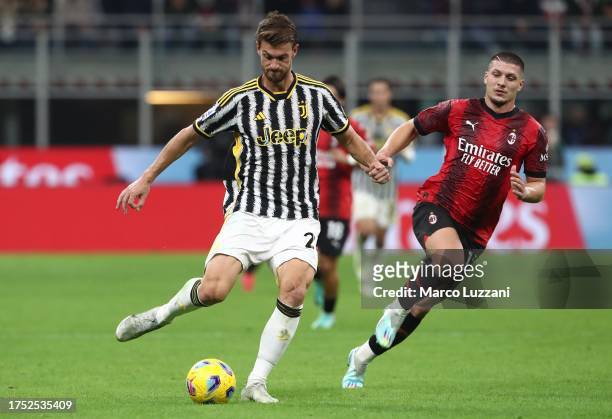 Daniele Rugani of Juventus FC is challenged by Luka Jovic of AC Milan during the Serie A TIM match between AC Milan and Juventus FC at Stadio...