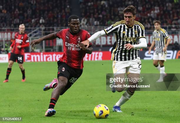 Yunus Musah of AC Milan battles for possession with Andrea Cambiaso of Juventus FC during the Serie A TIM match between AC Milan and Juventus FC at...
