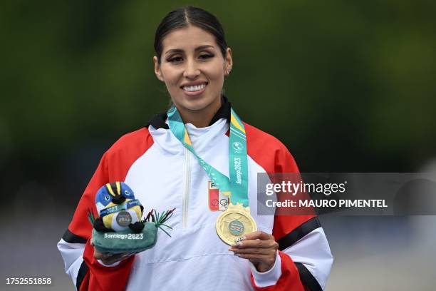 Peru's Gabriela Kimberly Garcia poses on the podium with her gold medal after the athletics women's 20km walk race during the Pan American Games...