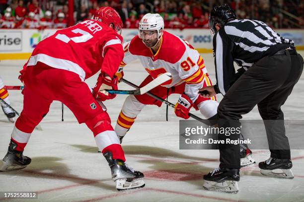 Nazem Kadri of the Calgary Flames faces off against J.T. Compher of the Detroit Red Wings during the second period at Little Caesars Arena on October...