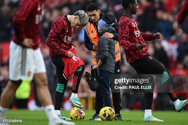 Child is grabbed by a steward after seeing nothing wrong in asking for an autograph while the players warm up ahead of the English Premier League...