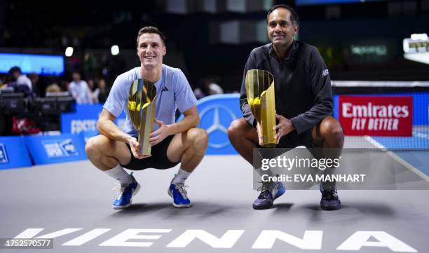 Britain's Joe Salisbury and USA's Rajeev Ram pose with their trophies after winning the final men's doubles match against USA's Nathaniel Lammons and...