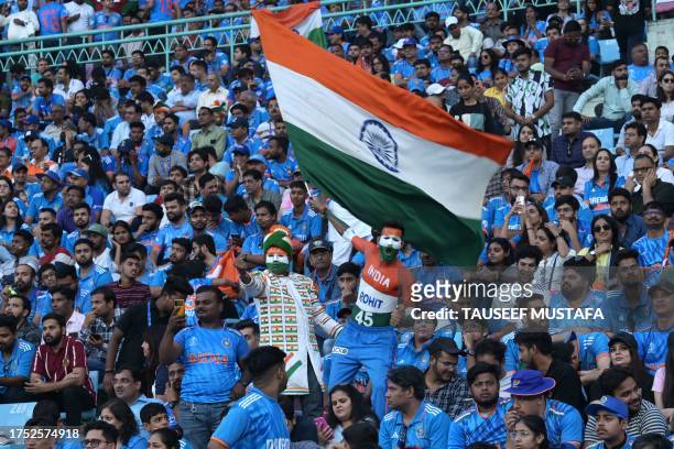 Fan waves India's national flag during the 2023 ICC Men's Cricket World Cup one-day international match between India and England at the Ekana...