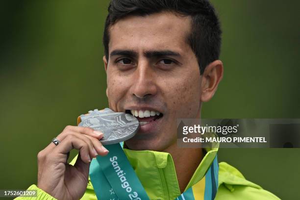 Brazil's Caio Oliveira de Sena Bonfim poses on the podium with his silver medal after the athletics men's 20km walk race during the Pan American...