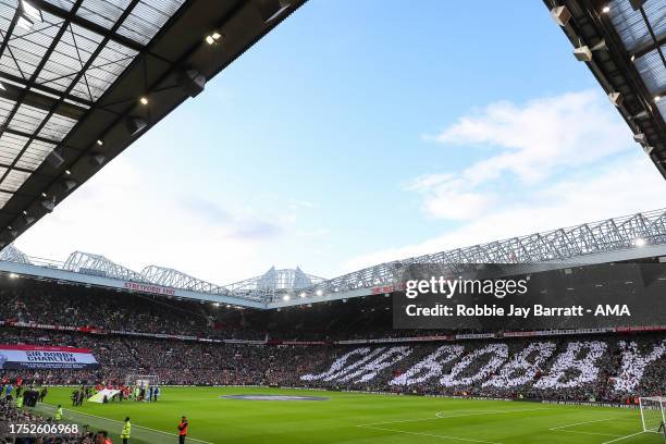 General view as both sets of fans pay their respects to the late Sir Bobby Charlton during the Premier League match between Manchester United and...