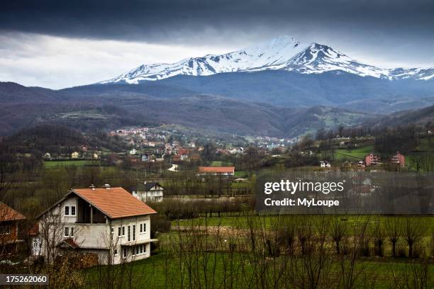 Kosovan landscape with farm and snow capped mountain