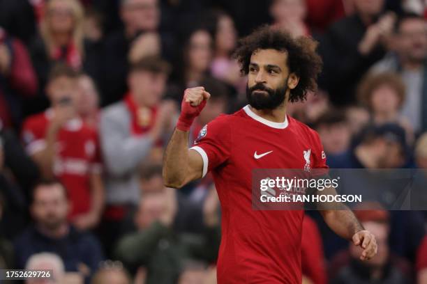 Liverpool's Egyptian striker Mohamed Salah celebrates after scoring their third goal during the English Premier League football match between...