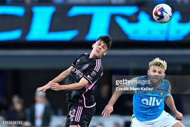 Kamil Jóźwiak of Charlotte FC and Noah Allen of Inter Miami jump to head the ball during the first half of their match at Bank of America Stadium on...