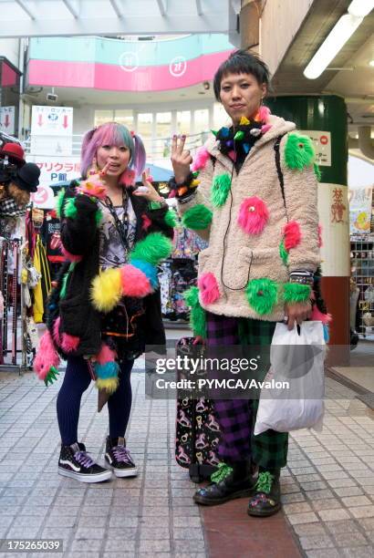 Young Japanese woman and man shopping in the Harajuku area of Tokyo, Japan 2009.
