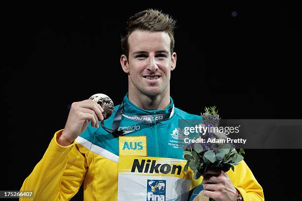 Gold medal winner James Magnussen of Australia celebrates on the podium the Swimming Men's Freestyle 100m Final on day thirteen of the 15th FINA...