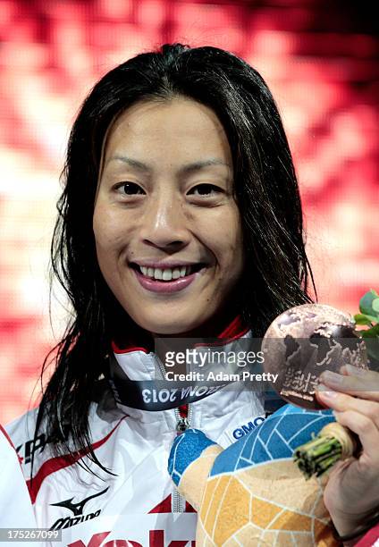 Bronze medal winner Aya Terakawa of Japan celebrates on the podium after the Swimming Women's Backstroke 50m Final on day thirteen of the 15th FINA...