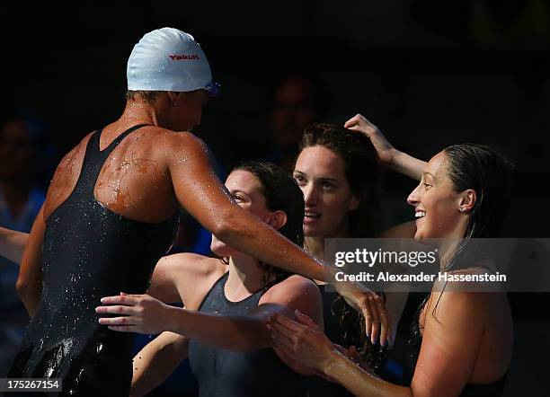 Coralie Balmy of France is embraced by teammates after the Swimming Women's Freestyle 4x200m Final on day thirteen of the 15th FINA World...