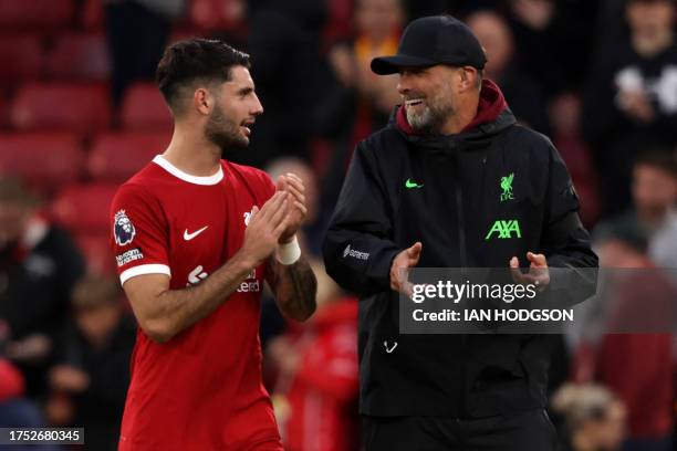 Liverpool's German manager Jurgen Klopp chats with Liverpool's Hungarian midfielder Dominik Szoboszlai after the English Premier League football...