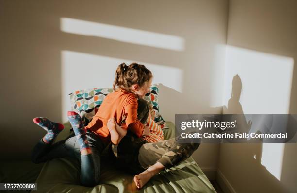 comical image of competitive wrestling siblings - sisters fighting stock pictures, royalty-free photos & images