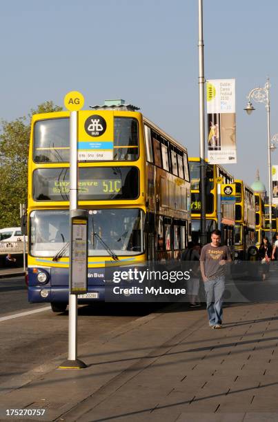 Yellow and Blue painted Dublin buses on Aston Quay in Dublin Ireland