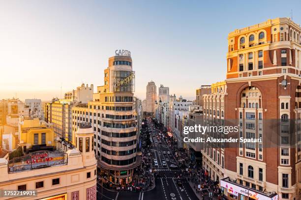 madrid cityscape with gran via street at sunset, aerial view, spain - madrid aerial stock pictures, royalty-free photos & images