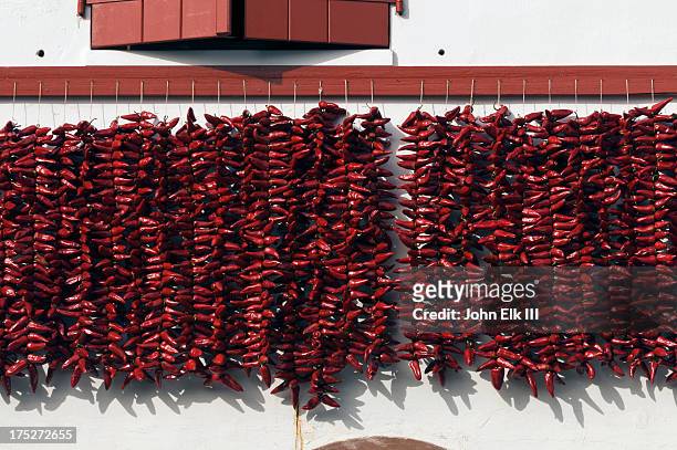 facade with drying basque chilis - pais vasco stock-fotos und bilder