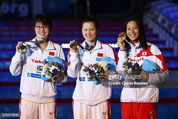 Silver medal winner Yuanhui Fu of China, Gold medal winner Jing Zhao of China and Bronze medal winner Aya Terakawa of Japan celebrate on the podium...