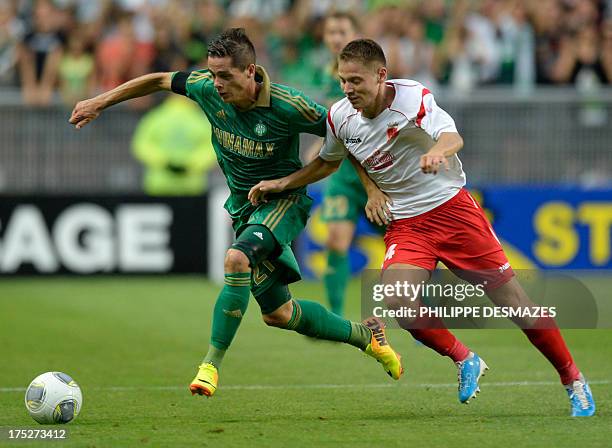 Saint-Etienne's French midfielder Romain Hamouma vies for the ball with Milsami's Moldavian defender Victor Gheorghiu during the UEFA Europa League...