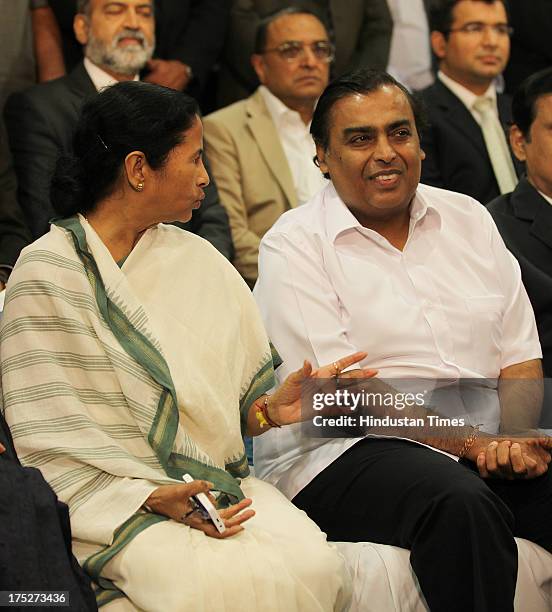 West Bengal Chief Minister Mamata Banerjee with Reliance Industry Chairman Mukesh Ambani, during the investors summit at World Trade Centre in...