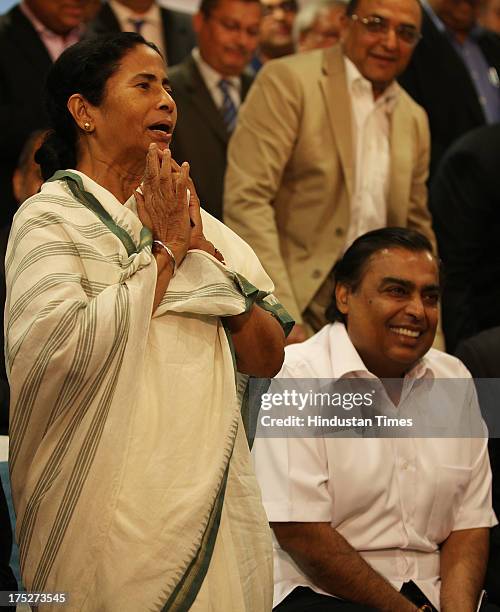 West Bengal Chief Minister Mamata Banerjee with Reliance Industry Chairman Mukesh Ambani during the investors summit at World Trade Centre on August...