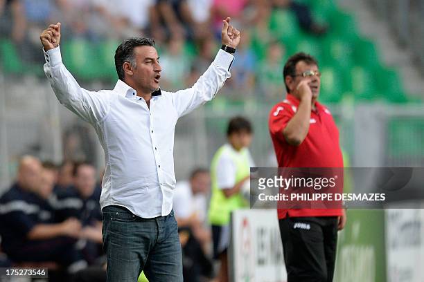 Saint-Etienne's French coach Christophe Galtier gestures next to Milsami's Moldovian coach Stefan Stoica during the UEFA Europa League preliminary...