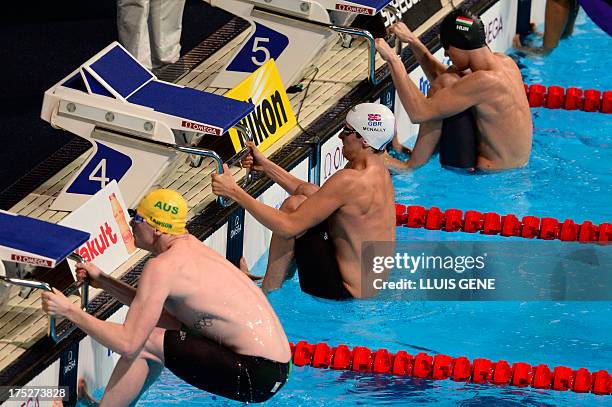 Australia's Matson Lawson, Britain's Craig McNally and Hungary's Peter Bernek compete in the semi-finals of the men's 200-metre backstroke swimming...