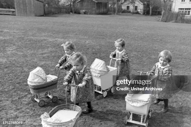 Knipser's quadruplet girls with their doll's prams, Germany 1930s.