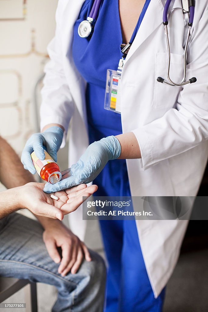 Doctor dispencing prescription pills