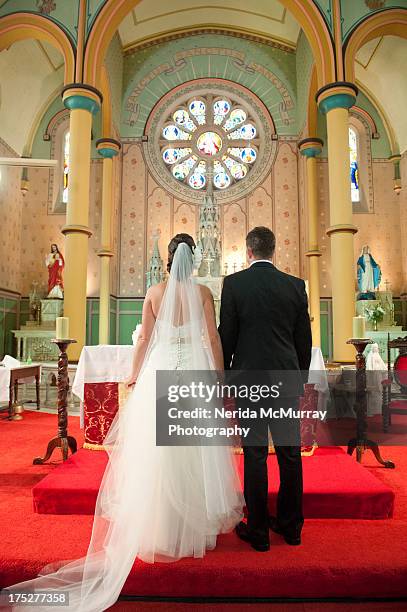 bride & groom at church - bruidegom stockfoto's en -beelden