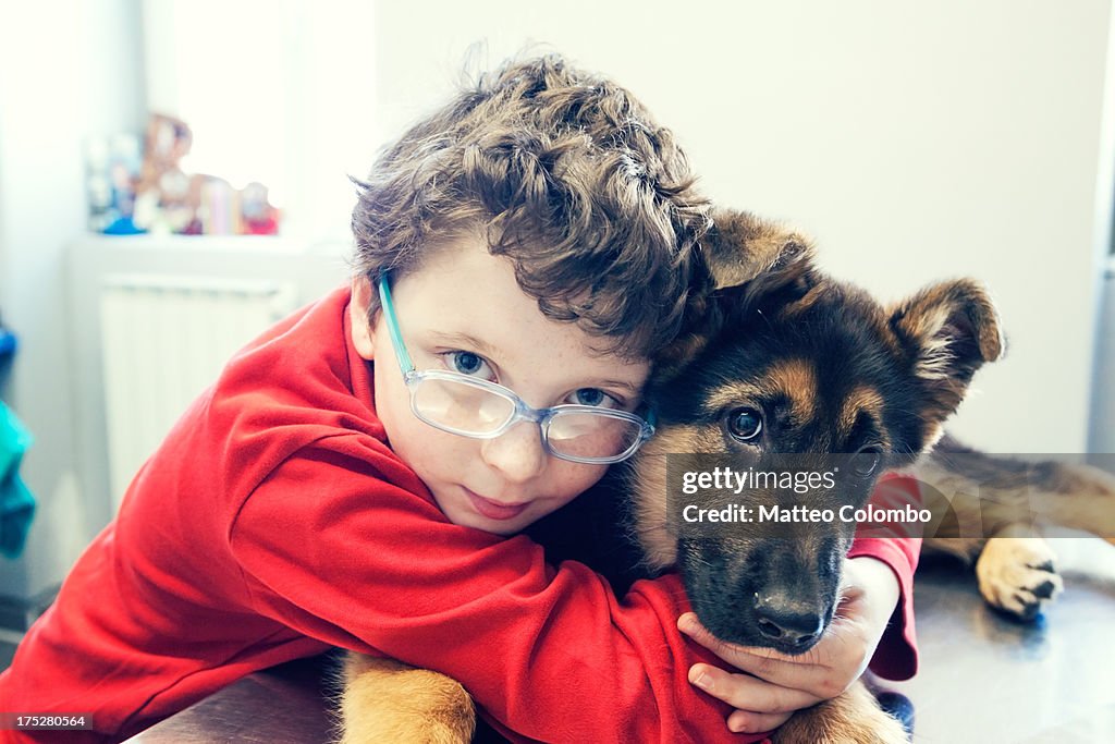 Child embracing dog at the veterinary