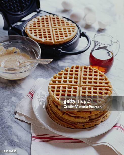 five grain waffles with waffle maker - waffle stock-fotos und bilder