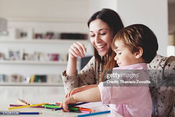 young mother help her son with drawing - boy brown hair stock pictures, royalty-free photos & images