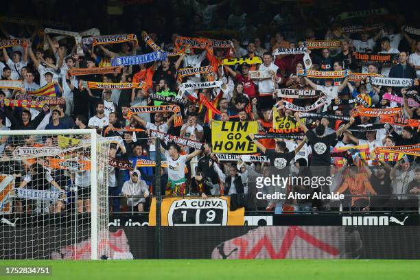 Fans of Valencia CF hold a sign which reads 'Lim Go Home' during the LaLiga EA Sports match between Valencia CF and Cadiz CF at Estadio Mestalla on...