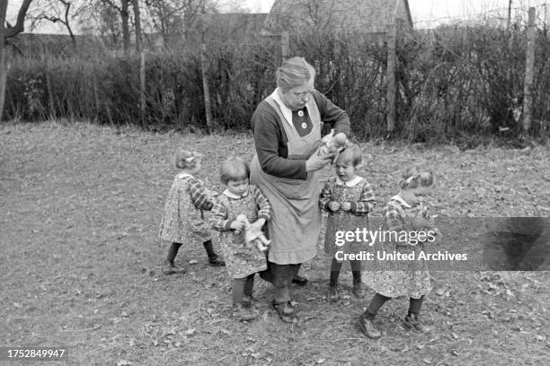 The Knipser's quadruplet girls playing at the garden, Germany 1930s.
