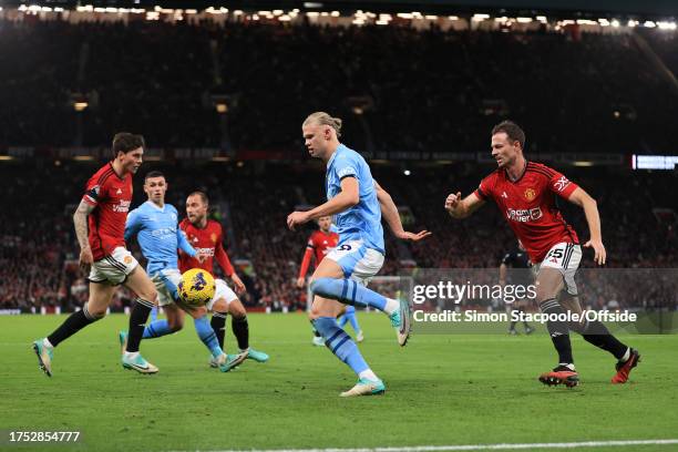 Erling Haaland of Manchester City battles with Jonny Evans of Manchester United during the Premier League match between Manchester United and...