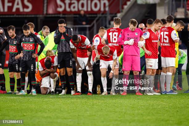 Players of NEC, players of AZ protecting the privacy of Bas Dost of NEC who is down on the ground with a medical emergency during the Dutch...